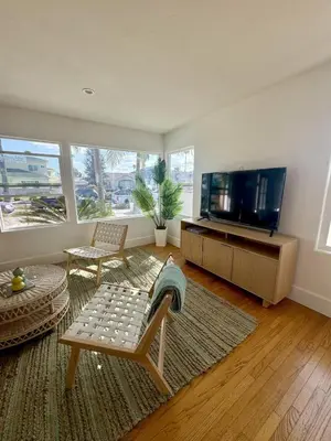 a living room with a couch and a tv at South O Surf House by Coastline Vacation Rentals in Oceanside