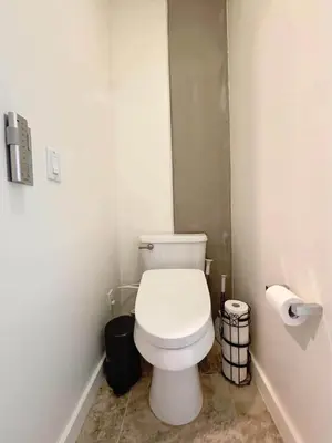 a bathroom with a white toilet in a room at Penthouse Industrial Loft & Parking Little Italy in San Diego