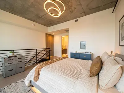 a bedroom with a large bed in a room at Penthouse Industrial Loft & Parking Little Italy in San Diego