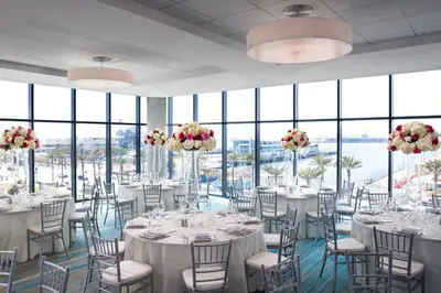 a banquet room with tables and chairs and windows at SpringHill Suites by Marriott San Diego Downtown/Bayfront in San Diego