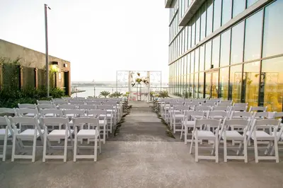 a row of white chairs in front of a building at SpringHill Suites by Marriott San Diego Downtown/Bayfront in San Diego