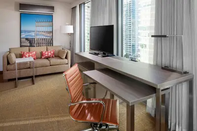 a hotel room with a desk and a couch at Residence Inn by Marriott San Diego Downtown/Bayfront in San Diego