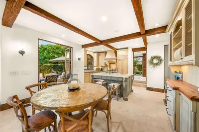 a kitchen and dining room with a table and chairs at The Stratford - Del Mar Luxury Living in San Diego