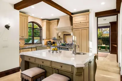 a kitchen with a large kitchen island with a sink at The Stratford - Del Mar Luxury Living in San Diego