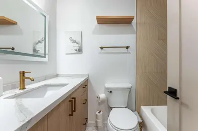 a white bathroom with a sink and a toilet at Pier-View Penthouse Condo in Pacific Beach in San Diego
