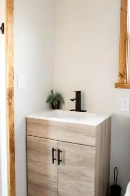 a bathroom sink with a faucet on top of it at Unplug in a Rustic-Chic Tiny Home: Stargazing Patio, Cookout Space & Nature Views in Aguanga, California in Aguanga