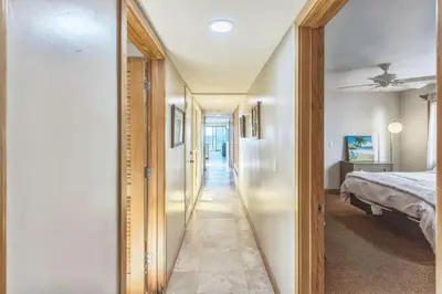 a hallway of a bedroom with a bed and a mirror at 450A Ocean View beach house in Dana Point