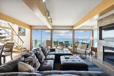 a living room with a couch and a fireplace at 450A Ocean View beach house in Dana Point