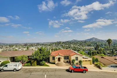 a house with two cars parked in a parking lot at 474 Oasis w Amazing Views Huge Pool in La Mesa
