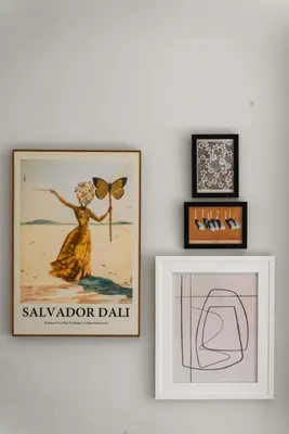 two framed pictures of a woman on a wall at The Treehouse by Coastline Vacation Rentals in San Diego