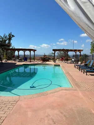 a swimming pool with a gazebo in the background at Painted sky casita in San Diego