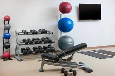 a room with a gym equipment with balls and a television at SpringHill Suites by Marriott San Diego Mission Valley in San Diego