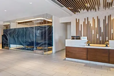a lobby with a reception desk and a large glass wall at Homewood Suites by Hilton San Diego Mission Valley/Zoo in San Diego