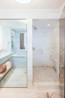 a bathroom with a shower with a glass door at Surf & Sand Laguna Beach in Laguna Beach