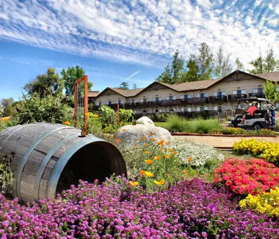 a garden with flowers in front of a hotel at Temecula Creek Inn in Temecula