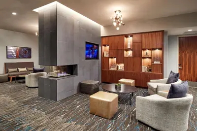 a living room with a fireplace and furniture at Homewood Suites by Hilton San Diego Downtown/Bayside in San Diego