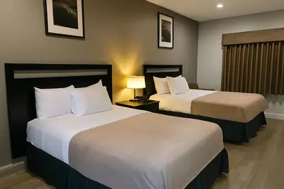 a hotel room with two beds and a window at Rodeway Inn El Cajon - San Diego East in El Cajon