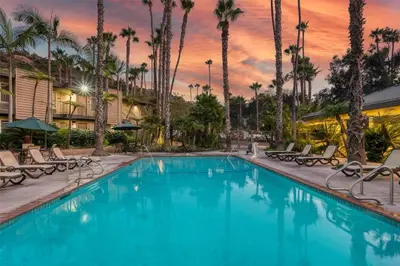 a swimming pool at a resort with palm trees at Best Western Seven Seas in San Diego