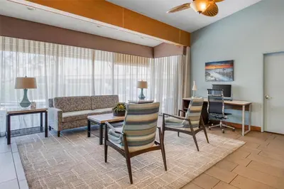 a living room with a couch and a table and chairs at Best Western Seven Seas in San Diego