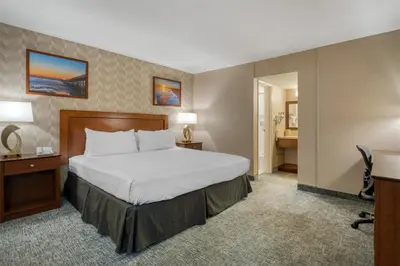 a hotel room with a bed and a desk at Best Western Seven Seas in San Diego