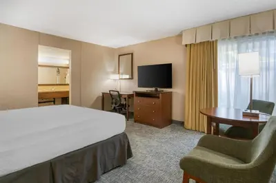 a hotel room with a bed and a desk and a television at Best Western Seven Seas in San Diego