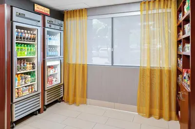 a room with an open refrigerator and a window at SpringHill Suites San Diego Rancho Bernardo/Scripps Poway in Poway