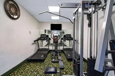 a room with a gym with a exercise bike at Super 8 by Wyndham San Diego Hotel Circle in San Diego