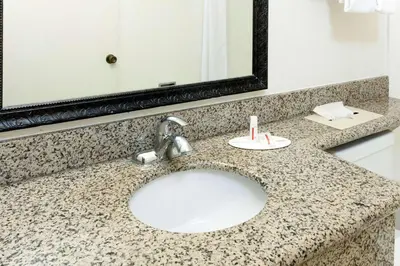 a bathroom counter with a sink and a mirror at Super 8 by Wyndham San Diego Hotel Circle in San Diego