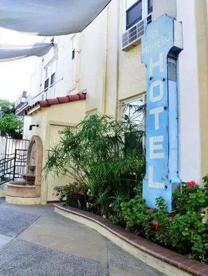 a building with a blue sign in front of it at El Primero Boutique Hotel in Chula Vista
