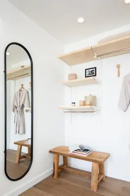 a mirror in a room with a wooden table at The Pearl Hotel in San Diego