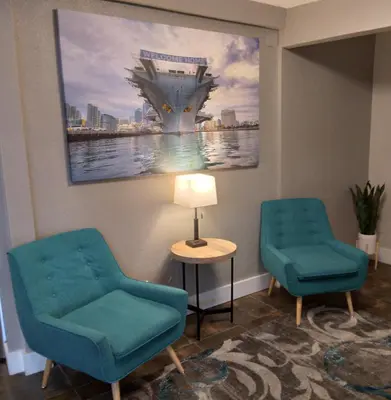 two chairs and a table in a waiting room at SureStay Hotel by Best Western Chula Vista San Diego Bay in Chula Vista
