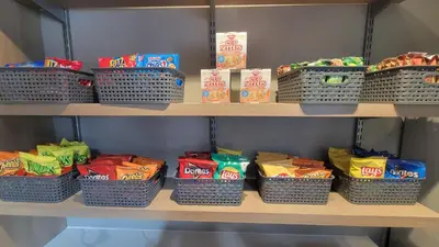 a shelf with baskets of chips and other snacks at SureStay Hotel by Best Western Chula Vista San Diego Bay in Chula Vista