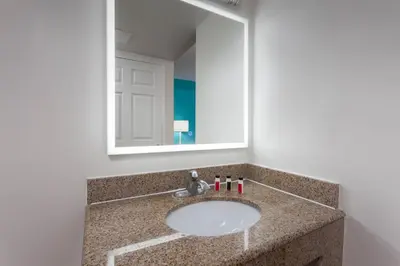 a bathroom with a sink and a mirror at Howard Johnson by Wyndham San Diego Hotel Circle in San Diego