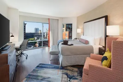 a hotel room with a bed and a desk and a tv at Hotel Indigo San Diego - Gaslamp Quarter by IHG in San Diego