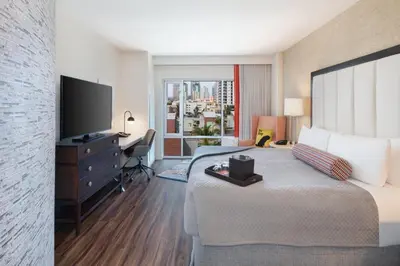 a hotel room with a large bed and a television at Hotel Indigo San Diego - Gaslamp Quarter by IHG in San Diego