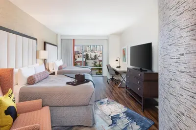 a hotel room with a bed and a desk and a tv at Hotel Indigo San Diego - Gaslamp Quarter by IHG in San Diego