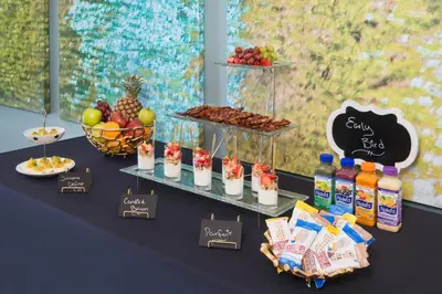 a table with fruit and drinks and snacks on it at Hotel Indigo San Diego - Gaslamp Quarter by IHG in San Diego