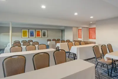 a conference room with white tables and chairs at Holiday Inn Express San Diego South - National City by IHG in National City