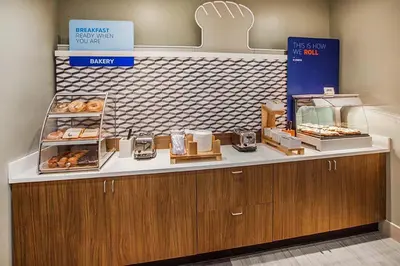 a bakery with a counter with donuts on it at Holiday Inn Express Hotel & Suites Lake Elsinore by IHG in Lake Elsinore