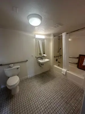 a bathroom with a toilet and a sink and a tub at Motel 6-San Diego, CA - Hotel Circle - Mission Valley in San Diego