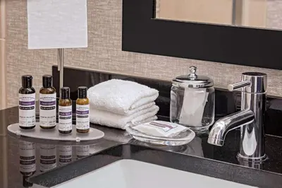 a bathroom sink with four bottles of essential oils on a counter at Hyatt Regency Mission Bay Spa and Marina in San Diego