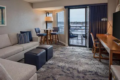 a living room with a couch and a table and a balcony at Hyatt Regency Mission Bay Spa and Marina in San Diego