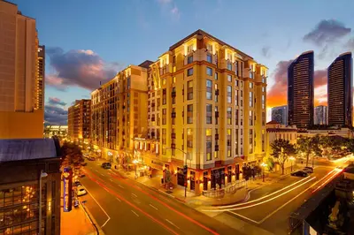 a tall yellow building on a city street at night at Residence Inn by Marriott San Diego Downtown/Gaslamp Quarter in San Diego