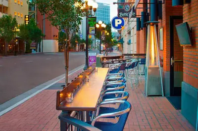 a row of tables and chairs on a city street at Residence Inn by Marriott San Diego Downtown/Gaslamp Quarter in San Diego