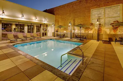 a pool in a hotel with chairs and tables at Residence Inn by Marriott San Diego Downtown/Gaslamp Quarter in San Diego