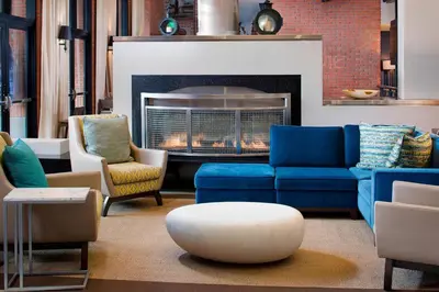 a living room with blue couches and a fireplace at Residence Inn by Marriott San Diego Downtown/Gaslamp Quarter in San Diego