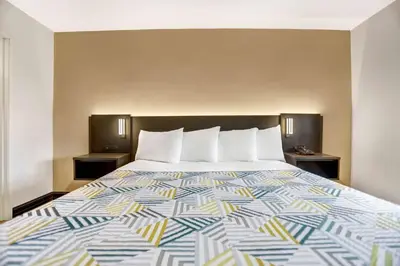 a bed in a hotel room with a colorful bedspread at Motel 6 San Diego, CA Airport Harbor in San Diego