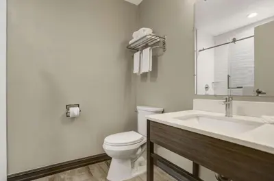 a white bathroom with a toilet and a sink at Motel 6 San Diego, CA Airport Harbor in San Diego