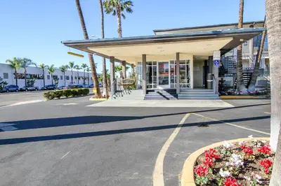 a building with a flower bed in the street at Motel 6 San Diego, CA Airport Harbor in San Diego