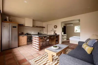 a kitchen and living room with a couch and a table at Los Bungalows in Imperial Beach